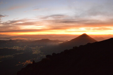 Sunrise hiking and camping on the active Volcan Acatenango with a view to the volcano Fuego eruption - Guatemala