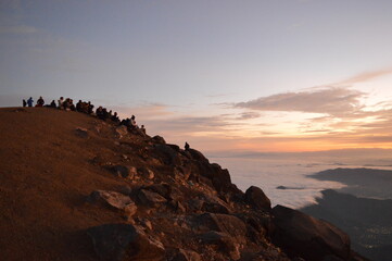 Sunrise hiking and camping on the active Volcan Acatenango with a view to the volcano Fuego eruption - Guatemala
