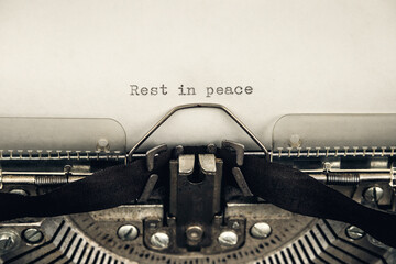 typing a message rest in peace on a vintage typewriter close-up