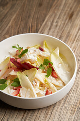 Endive salad with goat cheese, strawberry and walnuts.