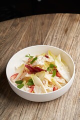 Endive salad with goat cheese, strawberry and walnuts.