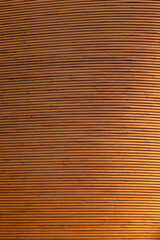 New and clean wall made of spruce tree's wood boards, viewed from the front. Right side is sunnier and brighter. High resolution full frame textured background.