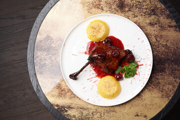 Grilled duck leg with polenta and sauce