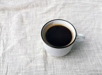 Black coffee mug cotton linen background.