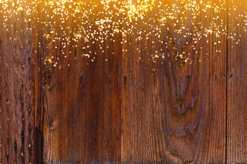 Golden bokeh lights with wooden background abstract desing