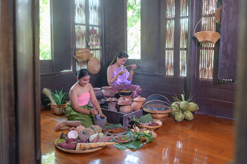 Thai woman cooking in retro Thai dress
