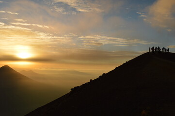 Sunrise hiking and camping on the top of the active Volcan Acatenango while the Volcano Fuego is erupting - Guatemala