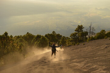 Sunrise hiking and camping on the top of the active Volcan Acatenango while the Volcano Fuego is erupting - Guatemala