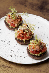 Salmon tartare with guacamole sauce, close-up