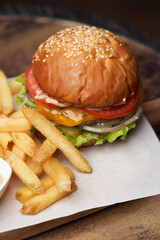 Cheeseburger with french fries and sauces
