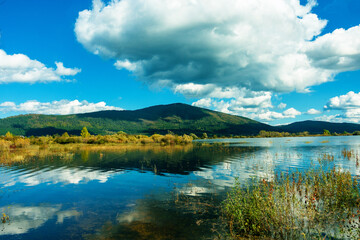 landscape with Cerknica lake and Alps mountains in autumn