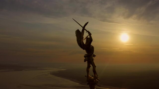 Aerial view of Archangel Michael statue on top of the abbey spiral France