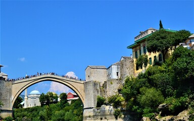 City of Mostar Bosnia and Hercegovina.Ancient and Ottoman City of Mostar and great Mostar Bridge. Neretva River and Vintage Buildings during sunny day and blue sky.