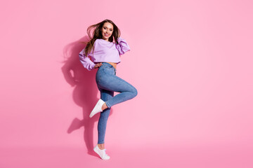 Full size photo of positive cheerful nice girl enjoy weekend trip want attract cute guy raise leg touch haircut fly wind wear style lilac jumper pullover isolated pastel color background