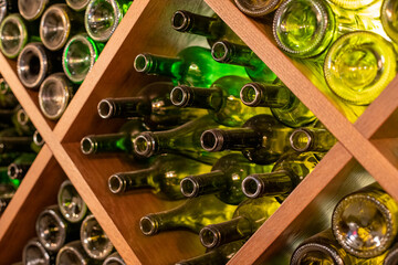 a lot of empty wine bottles are on the shelf