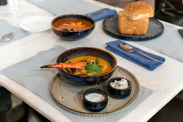 Bowl of Cioppino with Crab Claw (seafood stew) with shrimps, scallops, crabs, clams, mussels, and fish.