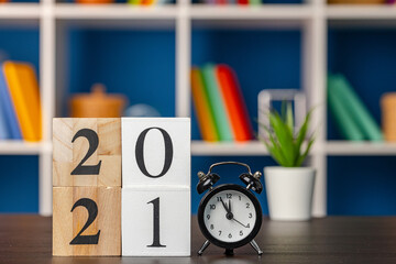 Wooden cubes with year 2021 on working table