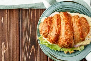 Croissant stuffed with bacon, cheese and lettuce