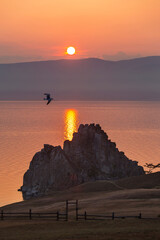 Naklejka na ściany i meble Views of Olkhon island and lake Baikal. Shamanka rock at Cape Burhan at sunset