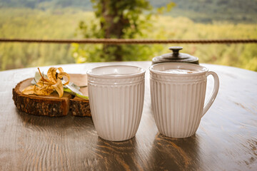 Tasty coffee served in the garden on old wooden table