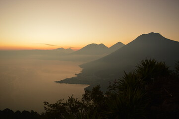 Obraz premium Sunrise over the volcanoes of Lake Atitlan in Guatemala, Central America