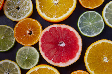 citrus fruit slices on dark surface
