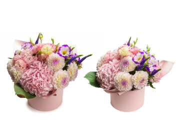Pink and purple bouquet of flowers in a pink box isolated on white.