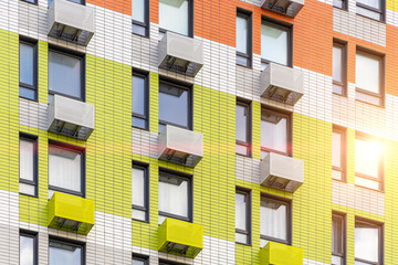 Multi-colored facade of modern multi-storey building, with compartments for installing air conditioners