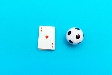 Toy Playing cards and soccer ball lying on a blue table with a paper background, photo inside