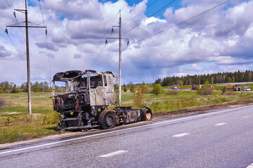 Fully burned truck on road