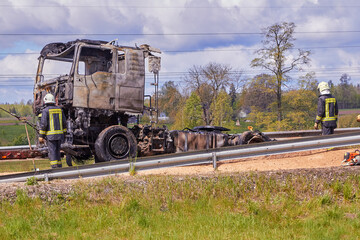 Fully burned truck on road