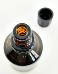 A jar of medicine, iodine, and green tea made of dark glass with an open lid