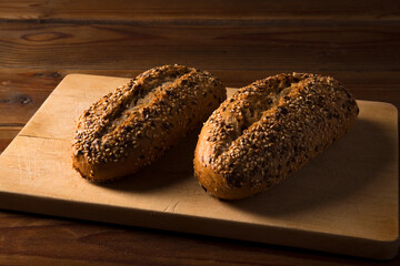 multigrain wholemeal bread with seeds on brown wooden table