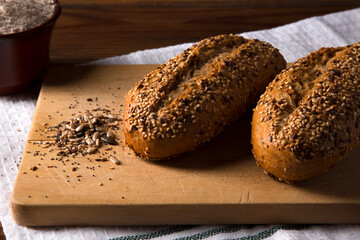 multigrain wholemeal bread with seeds on brown wooden table