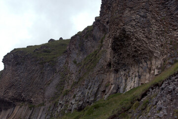Peaks and slopes of mountains in foggy weather. Elbrus region near the village of Terskol. Caucasus, Russia.
