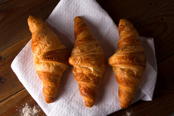 croissant on brown wooden table