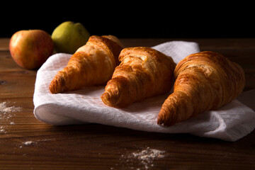 croissant on brown wooden table