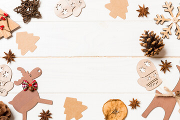 Top view of Christmas decorations and toys on wooden background. Copy space. Empty place for your design. New Year concept