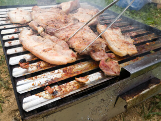 The concept of fast and delicious food. Frying meat on the grill.