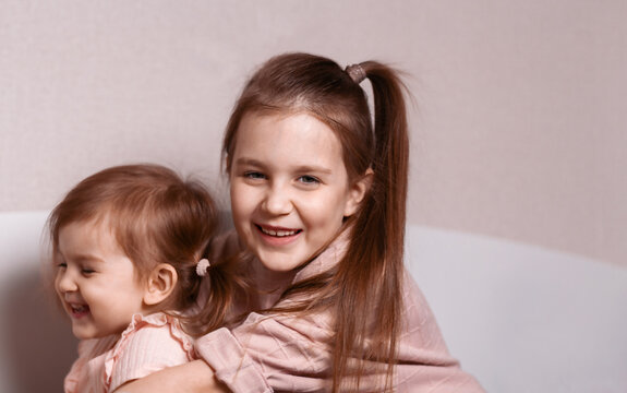 Portrait Of Two Happy Little Girls.