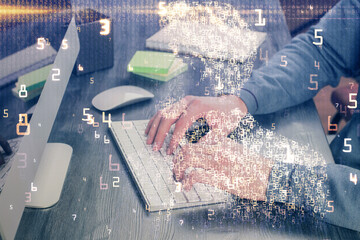 Technology theme hologram with man working on computer on background. High tech concept. Multi exposure.