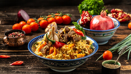 Traditional uzbek meal called pilaf. Rice with meat, carrot and onion in plate with oriental ornament, Uzbek oriental cuisine. Long banner format. space for text