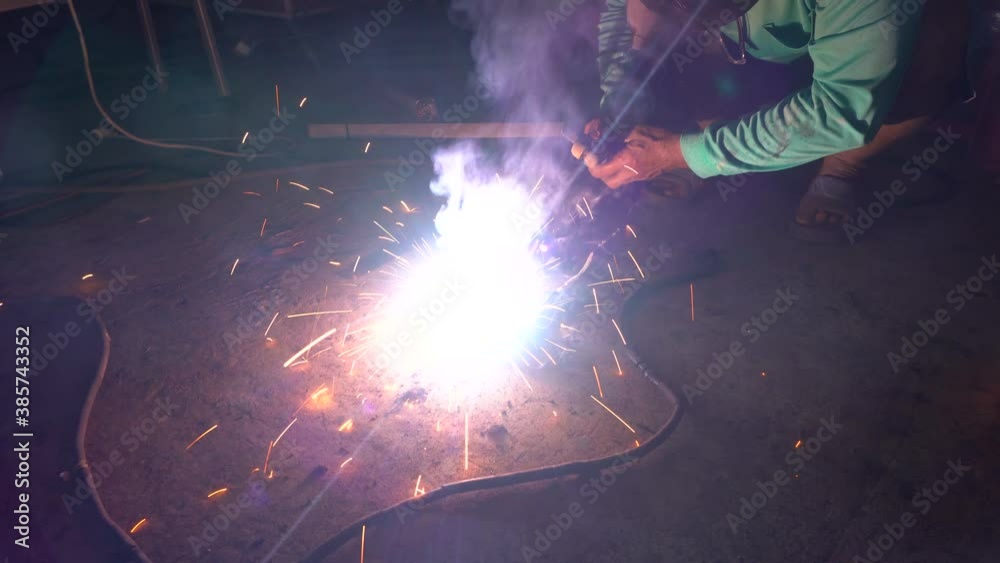 Wall mural Welder welding the worker electric welding at the  construction site or factory .