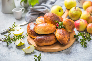 Ready-made baked pies (pirogi) with apple. Traditional russian cuisine.
