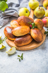 Ready-made baked pies (pirogi) with apple. Traditional russian cuisine.