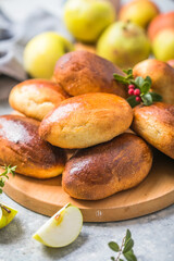 Ready-made baked pies (pirogi) with apple. Traditional russian cuisine.