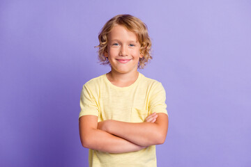 Photo of attractive boy look in camera cross hands isolated over purple pastel color background