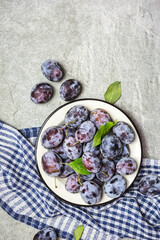 Ripe blue plums on a plate