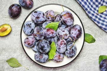Ripe blue plums on a plate