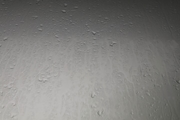 Water droplets on the hood after rain on a stormy day reflected in the gloomy sun all day on warm cold evenings. Quiet and lonely, scary